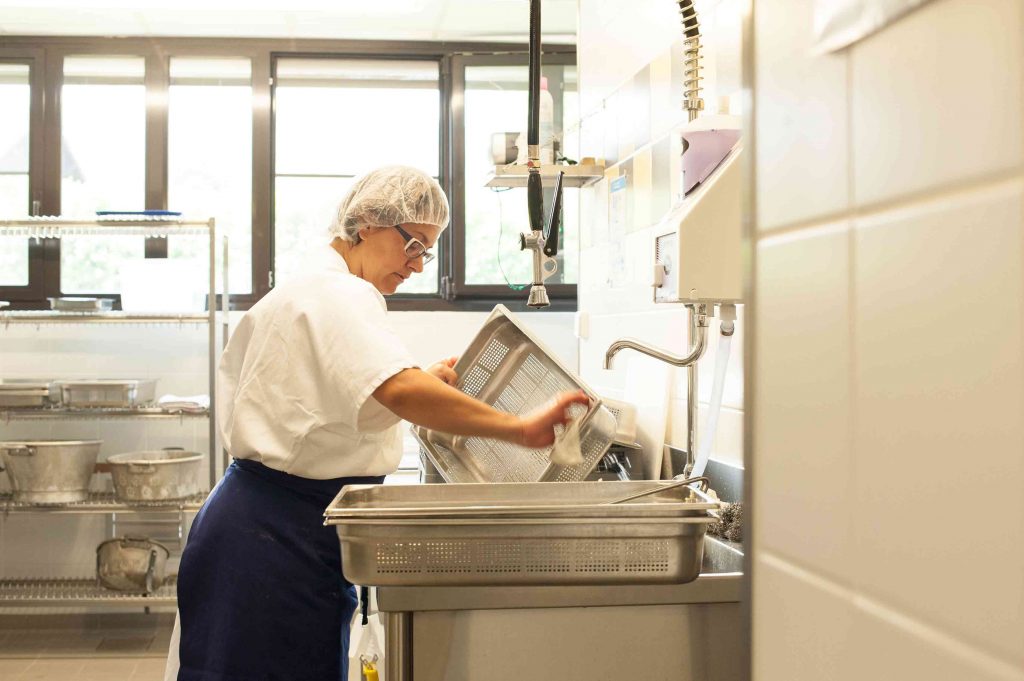 cleaning up in French school cafeteria kitchen